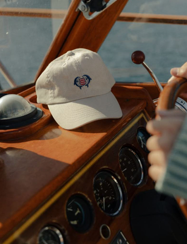 A club cap on the helm of a boat