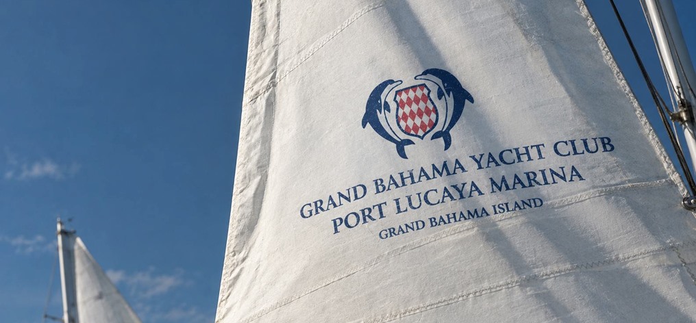 Sail printed with the Grand Bahama Yacht Club, Port Lucaya Marina crest against blue sky
